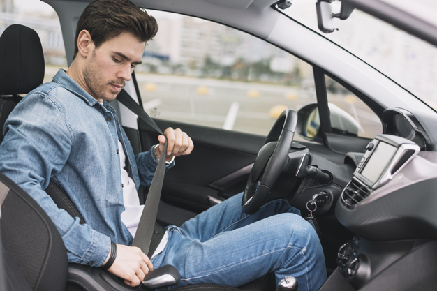 side-view-young-man-sitting-inside-car-putting-safety-belt_23-2147937335.jpg